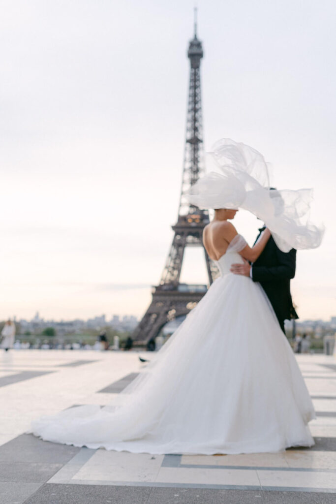 bride and groom in front of Eiffel Tower 